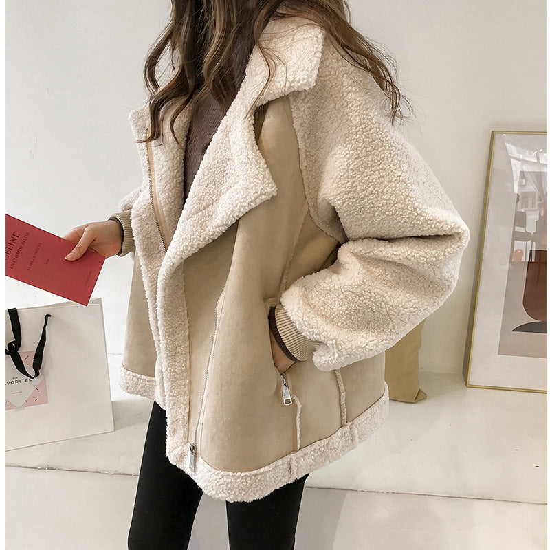 Beige sherpa jacket worn by a person indoors with a neutral background