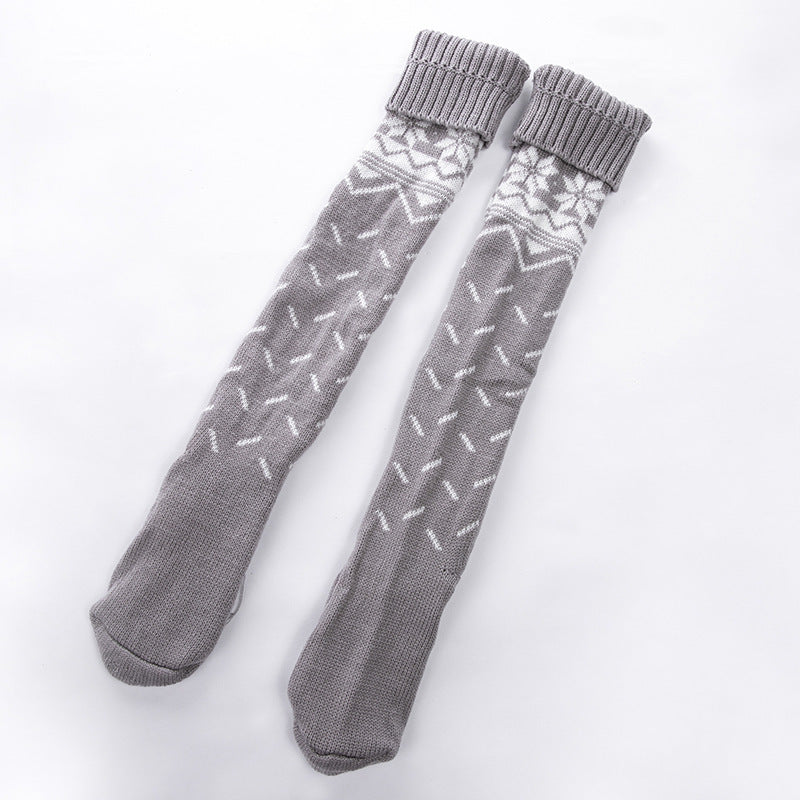 Pair of gray socks with a subtle pattern on a white background