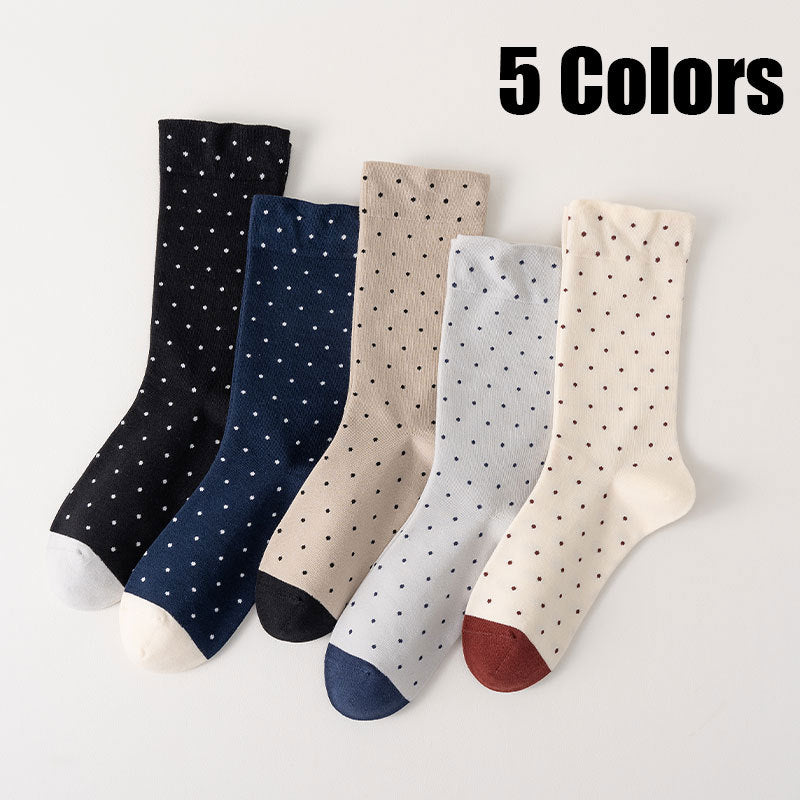 Five pairs of polka dot socks in different colors on a light gray background.