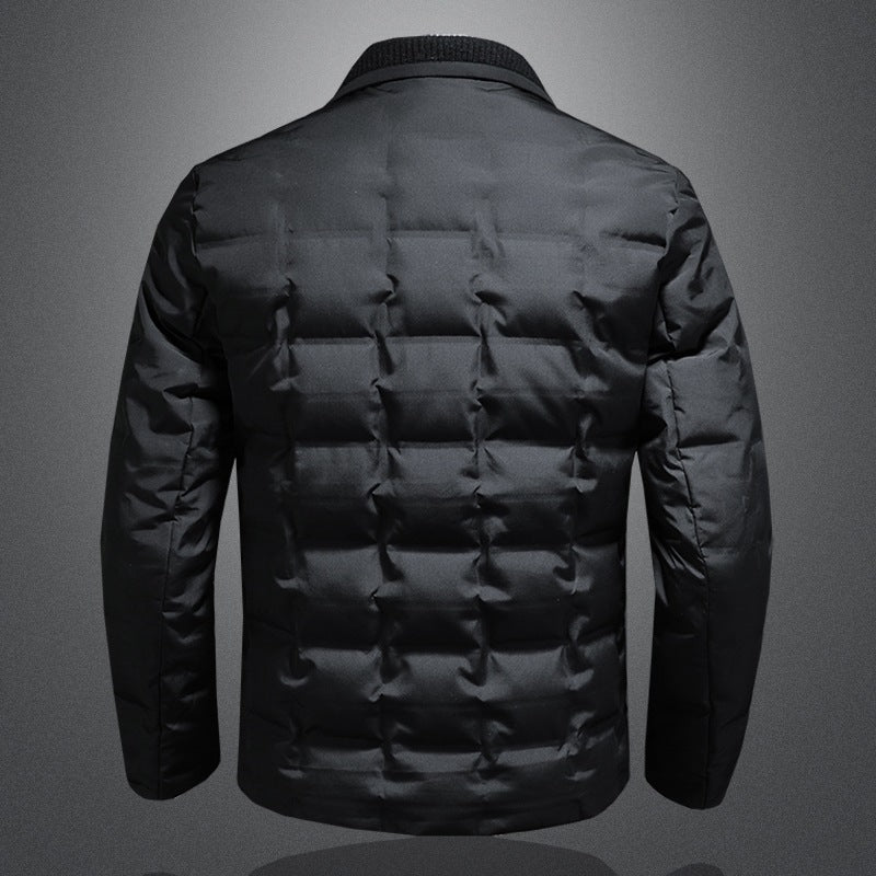 Black puffer jacket on a gray background