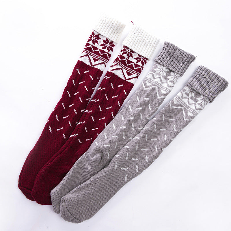 Two pairs of patterned socks, one red and white, one gray and white, on a white background.