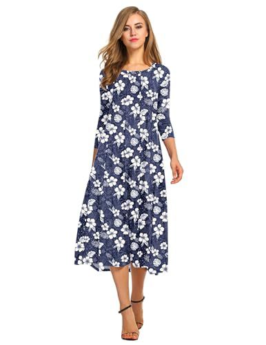 Woman wearing a navy blue dress with white floral pattern on a white background