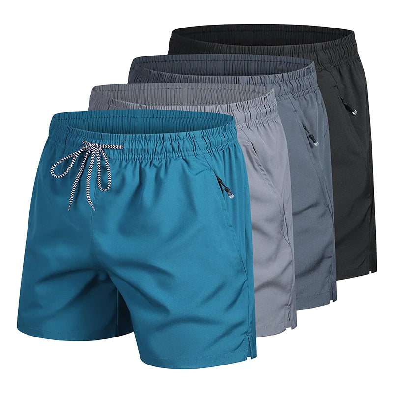 Four men’s quick-dry beach shorts in blue, gray, light gray and black with elastic waistband and zip pockets on a white background.