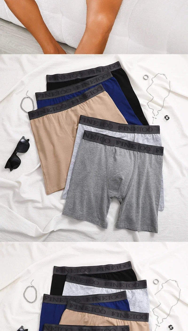 Four pairs of men's underwear in gray, black, beige, and blue on a white background.