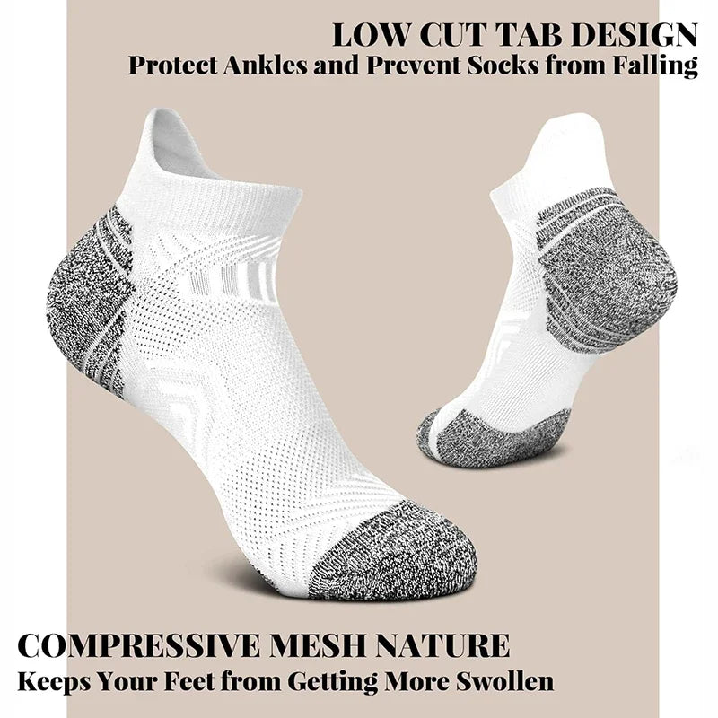 White ankle socks with gray accents on a beige background, highlighting low cut tab design and compressive mesh nature.
