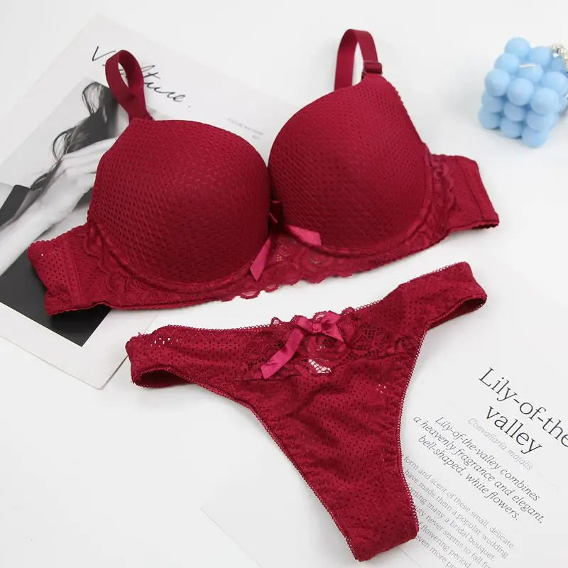 Red bra and panties set on a magazine page with 'Lily of the Valley' text.