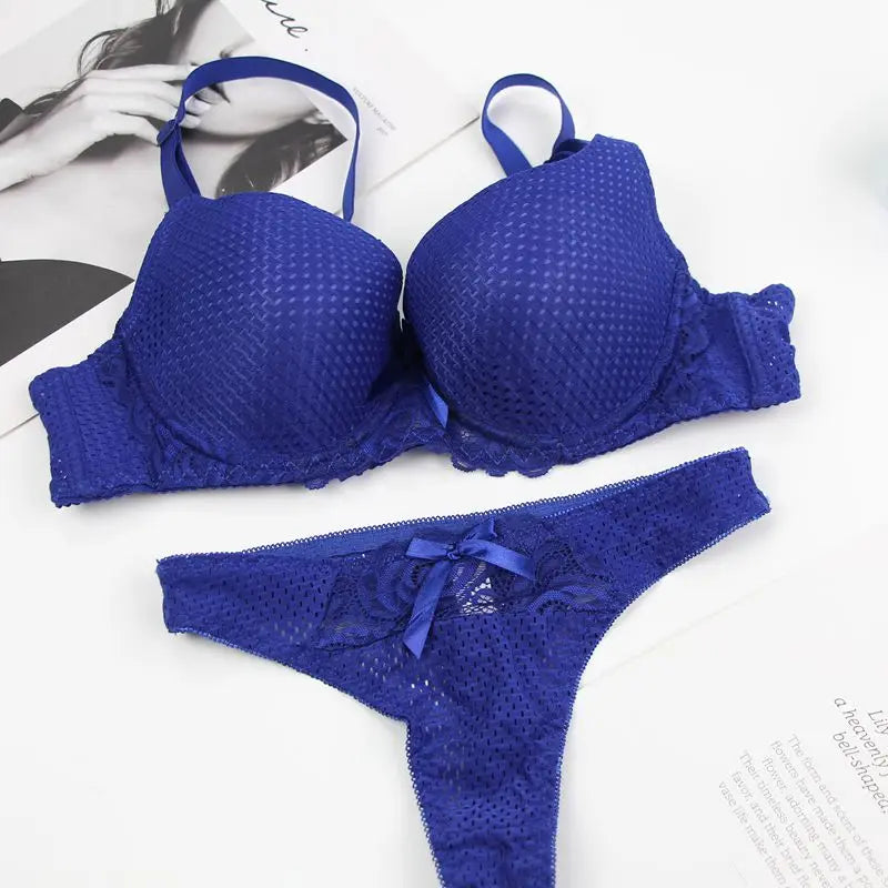 Blue lingerie set with bra and panties on a white background