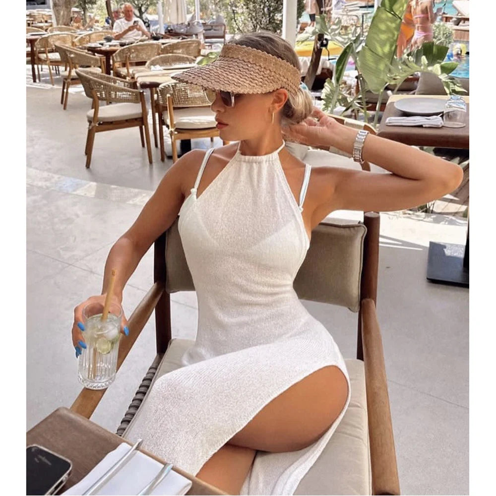Woman in a white dress sitting at an outdoor cafe