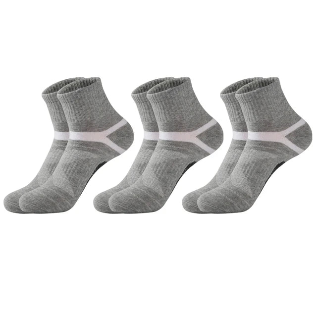 Three pairs of gray socks with white stripes on a white background
