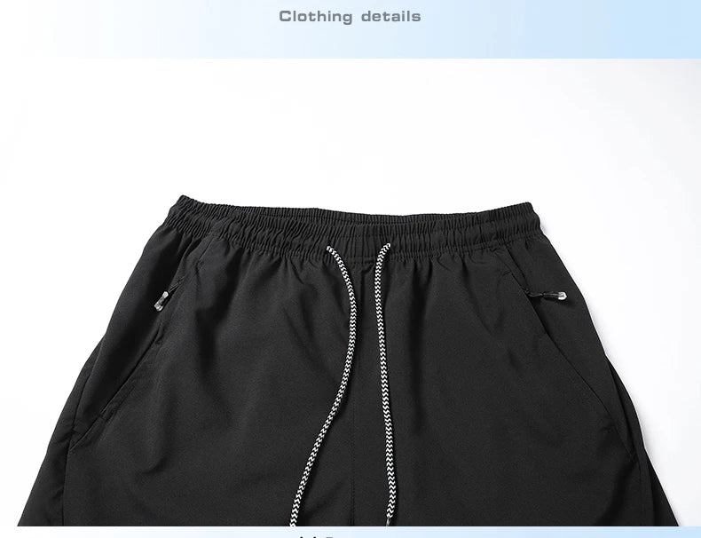 Black pants with a zipper detail on a light gray background