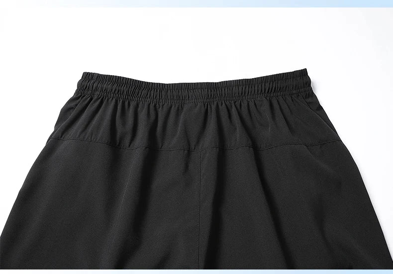 Close-up of black shorts with an elastic waistband on a white background