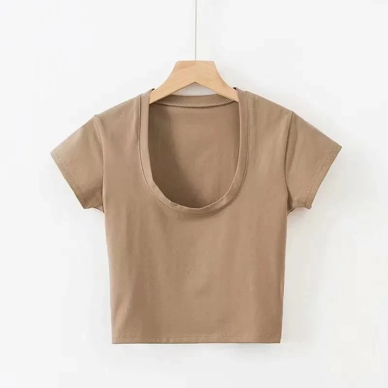 Beige t-shirt on a wooden hanger against a white background