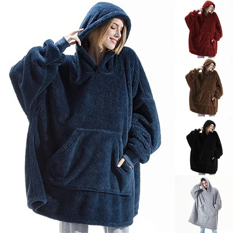 Blue fleece poncho with hood worn by a person, displayed against a white background.