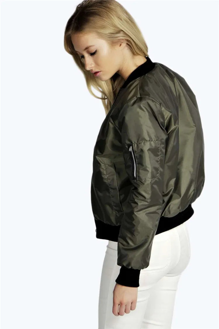 Woman wearing a olive green bomber jacket on a white background