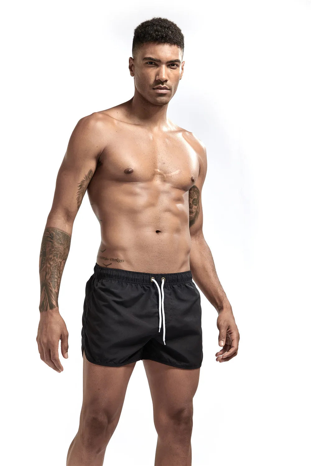 Man wearing black swim shorts on a white background