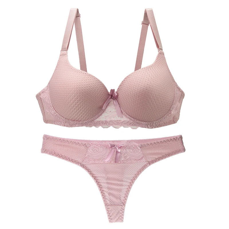 Pink bra and panties set on a white background