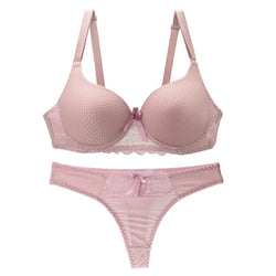 Pink bra and panties set on a white background