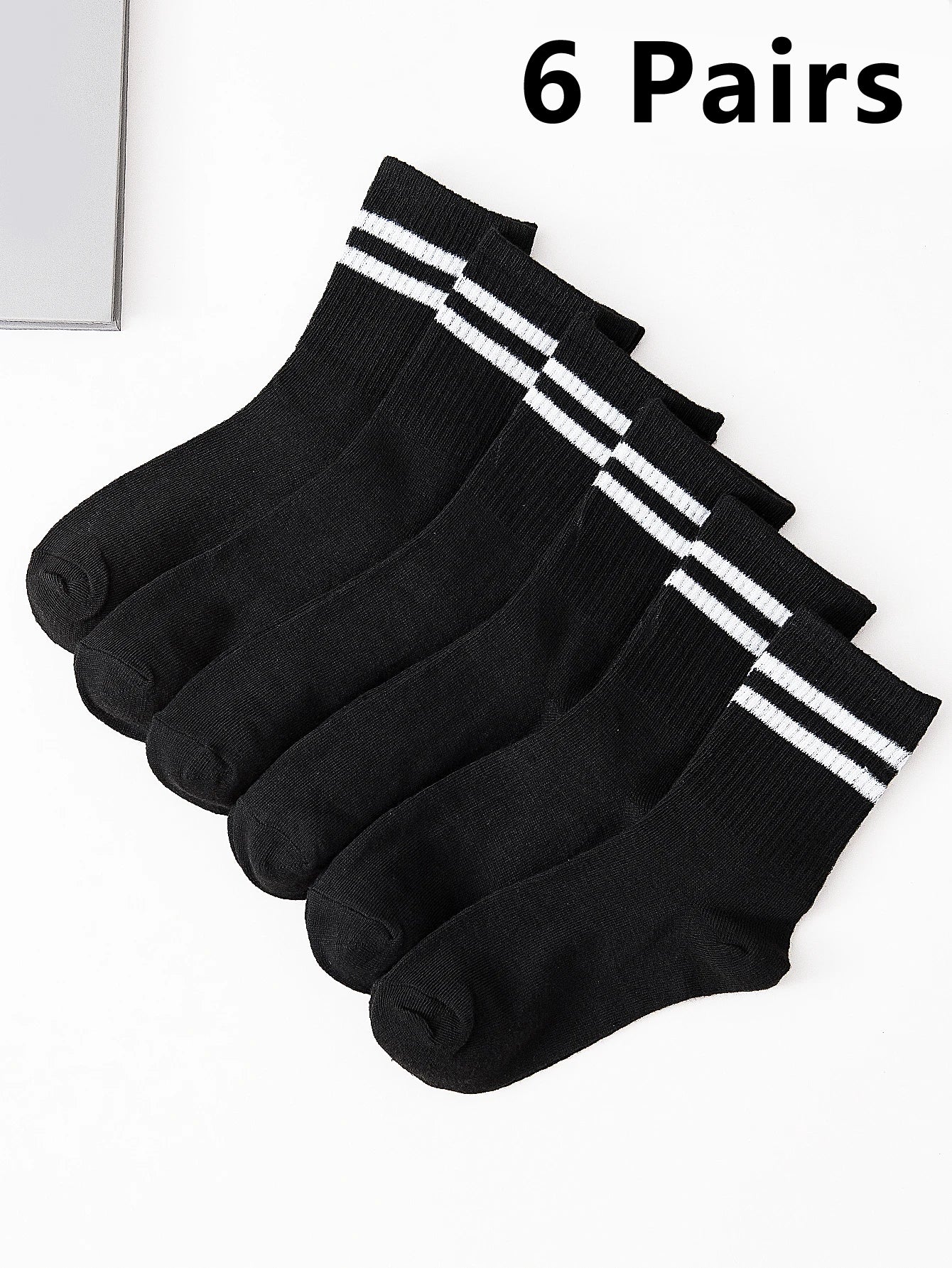 Six pairs of black socks with white stripes on a white background