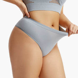 Person wearing light gray underwear on a white background
