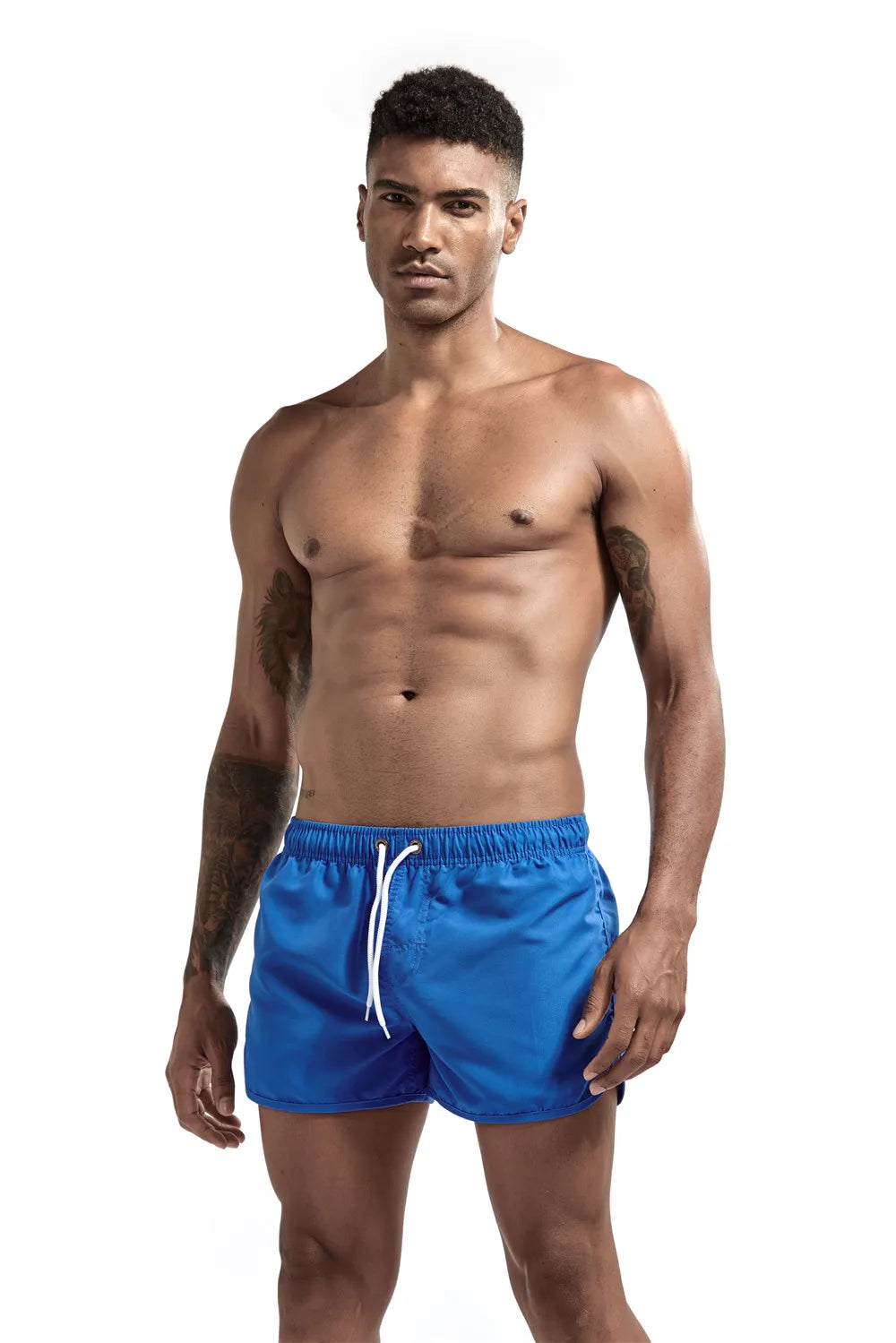 Man wearing blue swim shorts on a white background