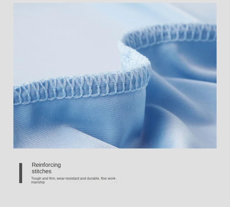 Close-up of blue fabric with reinforcing stitches on a light gray background