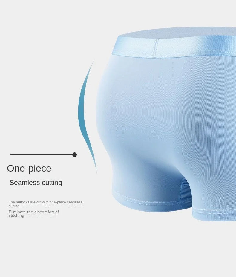 Light blue men's underwear with 'One-piece Seamless Cutting' text on a light gray background