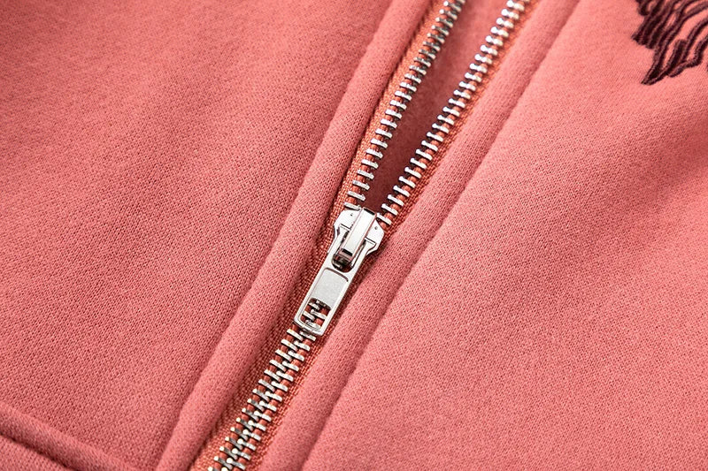 Close-up of a pink jacket with a silver zipper