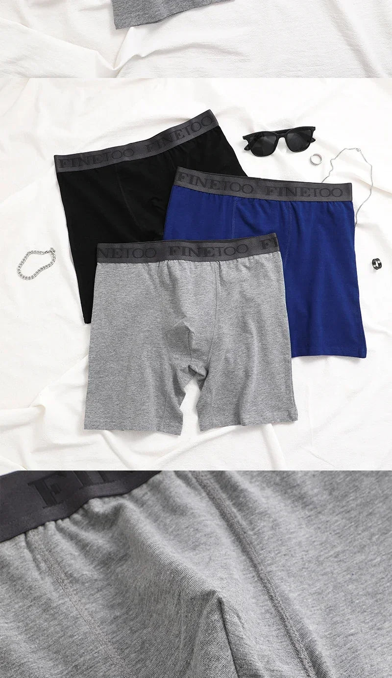 Three pairs of men's underwear in black, blue, and gray on a white background.