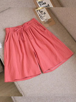 A collage of images showing women's high waist loose shorts with pockets in various colors including blue, pink, beige, and green.
