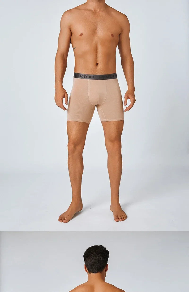 Man wearing beige boxer briefs with a white background