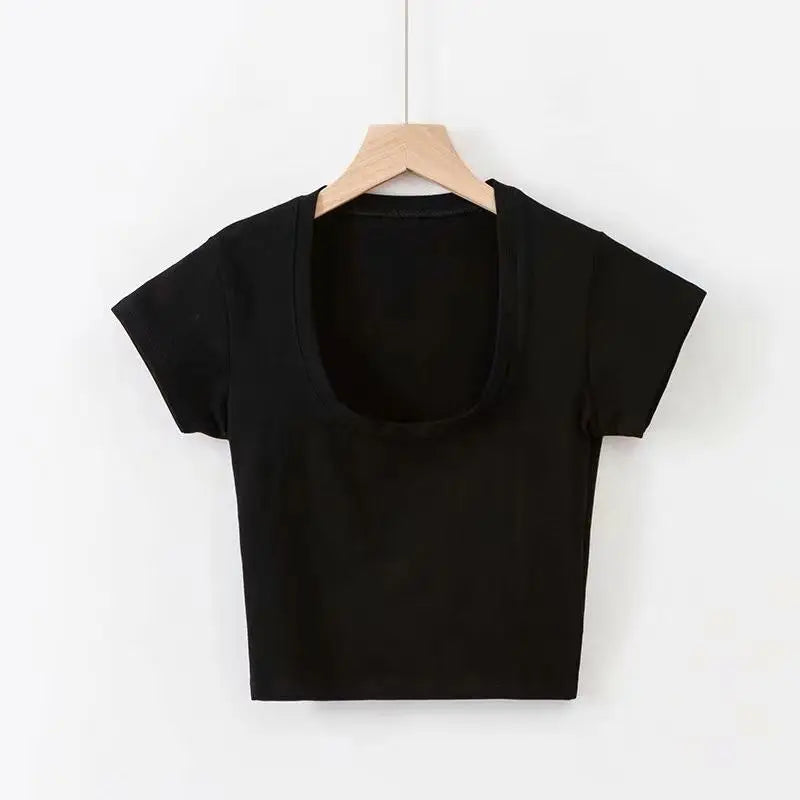 Black crop top on a wooden hanger against a white background