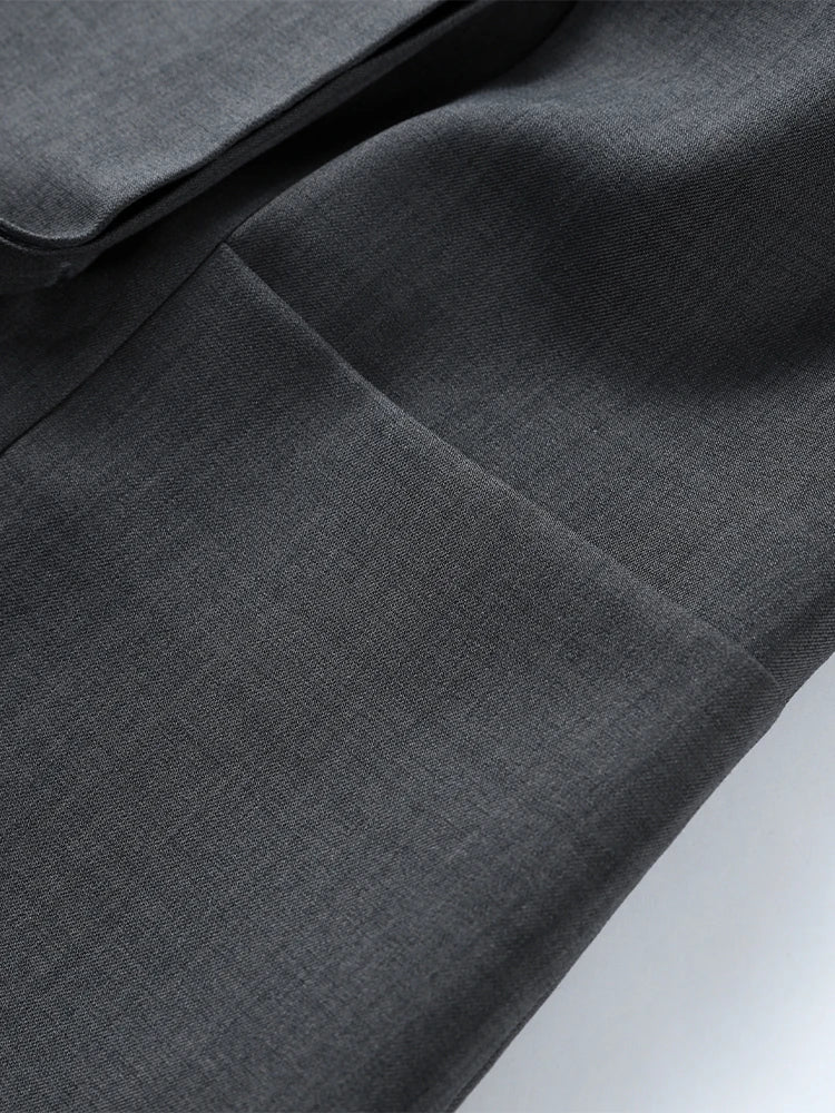 Close-up of gray fabric with a subtle pattern on a white background