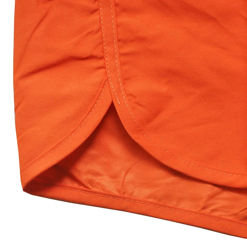 Close-up of orange fabric with a visible seam on a white background
