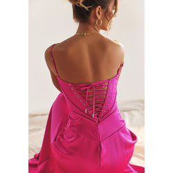 Pink evening gown with lace-up back worn by a model on a neutral background