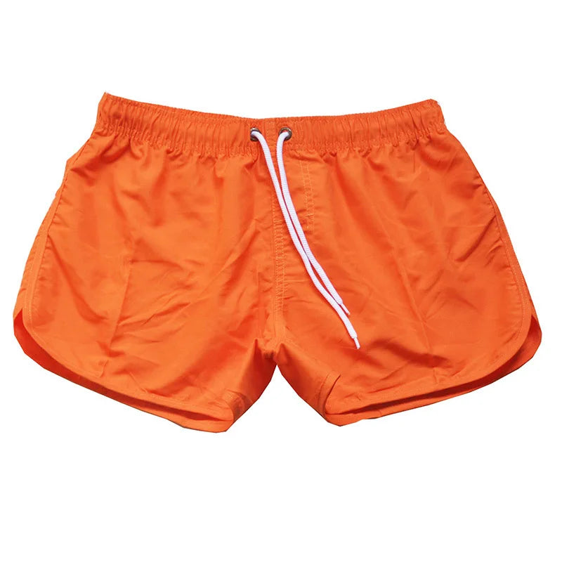 Orange shorts with a white drawstring on a white background