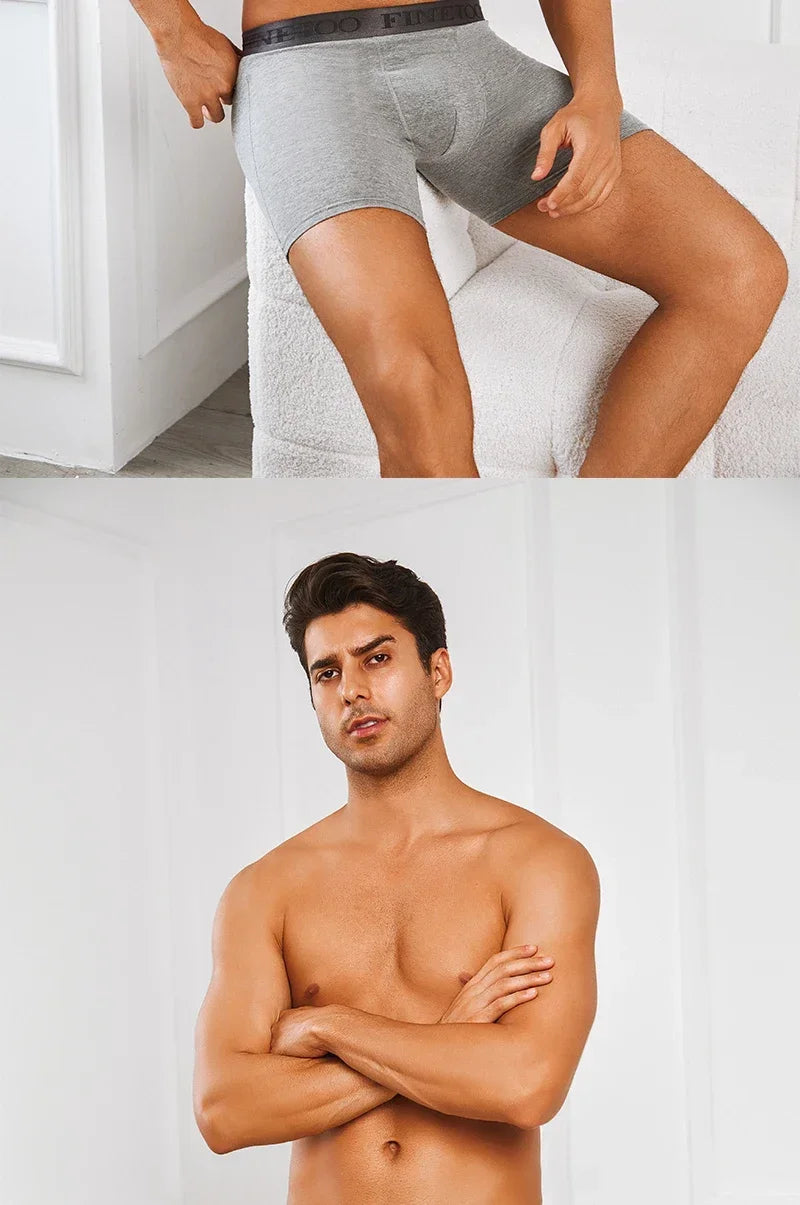 Man wearing gray boxer briefs with a plain background
