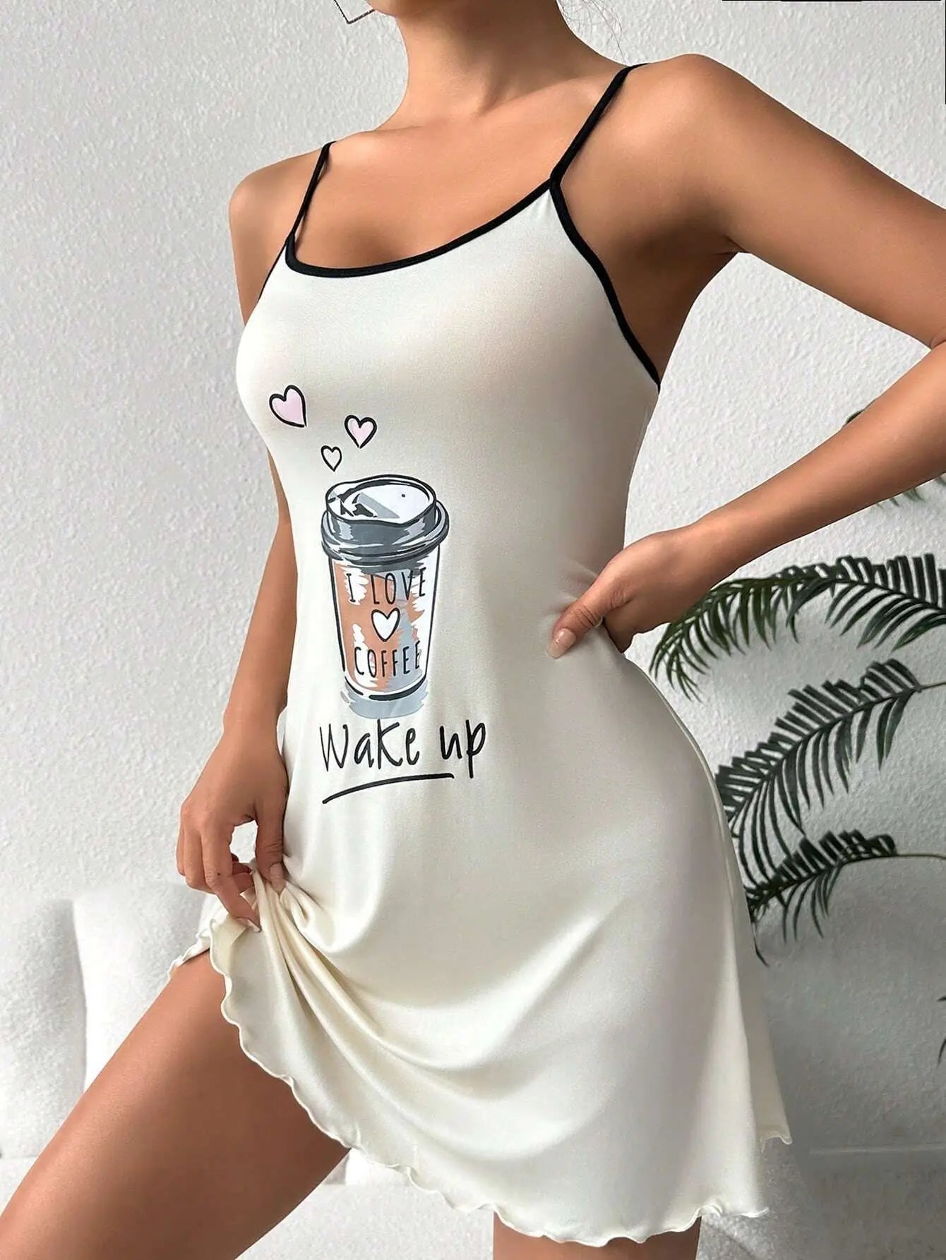 White nightgown with coffee cup design and 'Wake up' text on a plain background