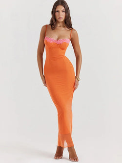 Woman wearing an orange dress with pink lace details on a white background