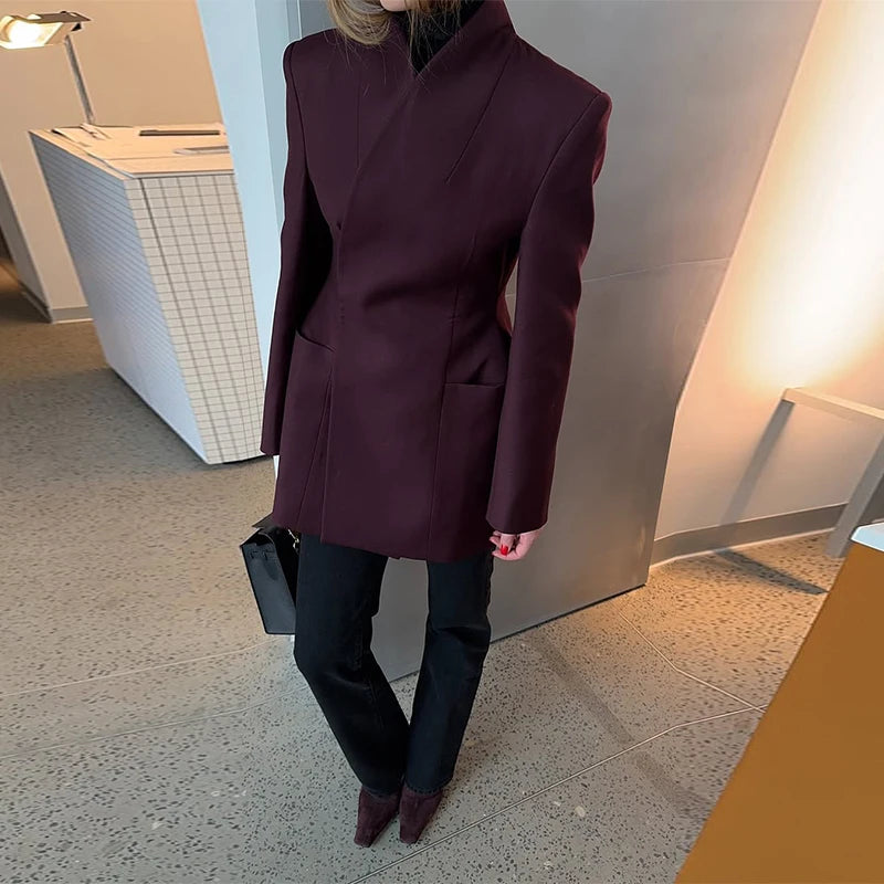 Person wearing a wine red coat in an indoor setting