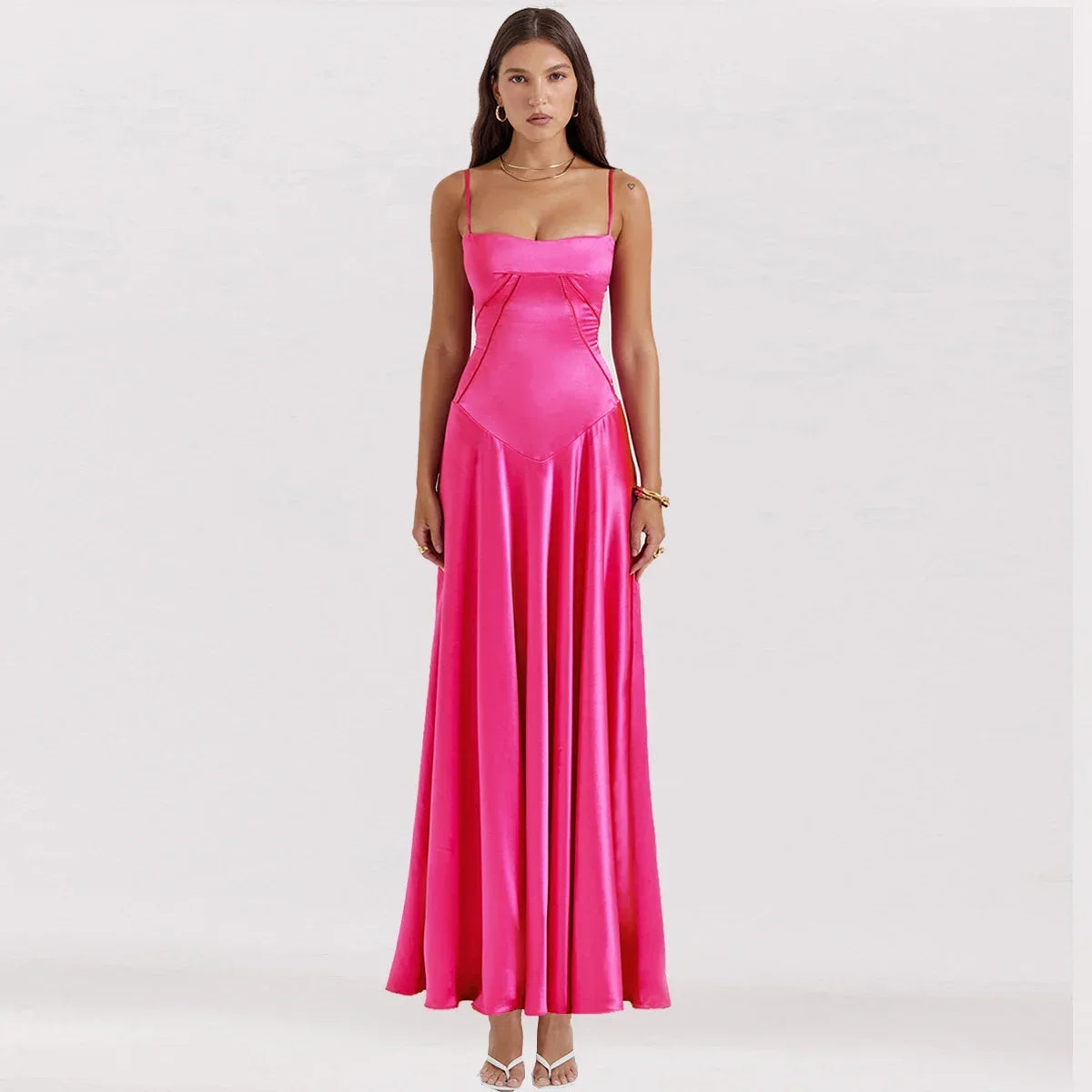 Woman wearing a bright pink evening gown on a white background