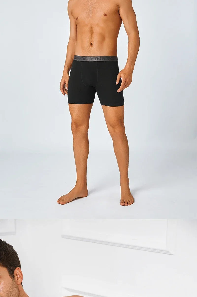 Man wearing black boxer briefs on a white background