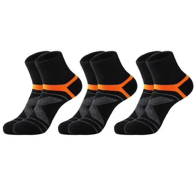 Set of black socks with orange accents on a white background