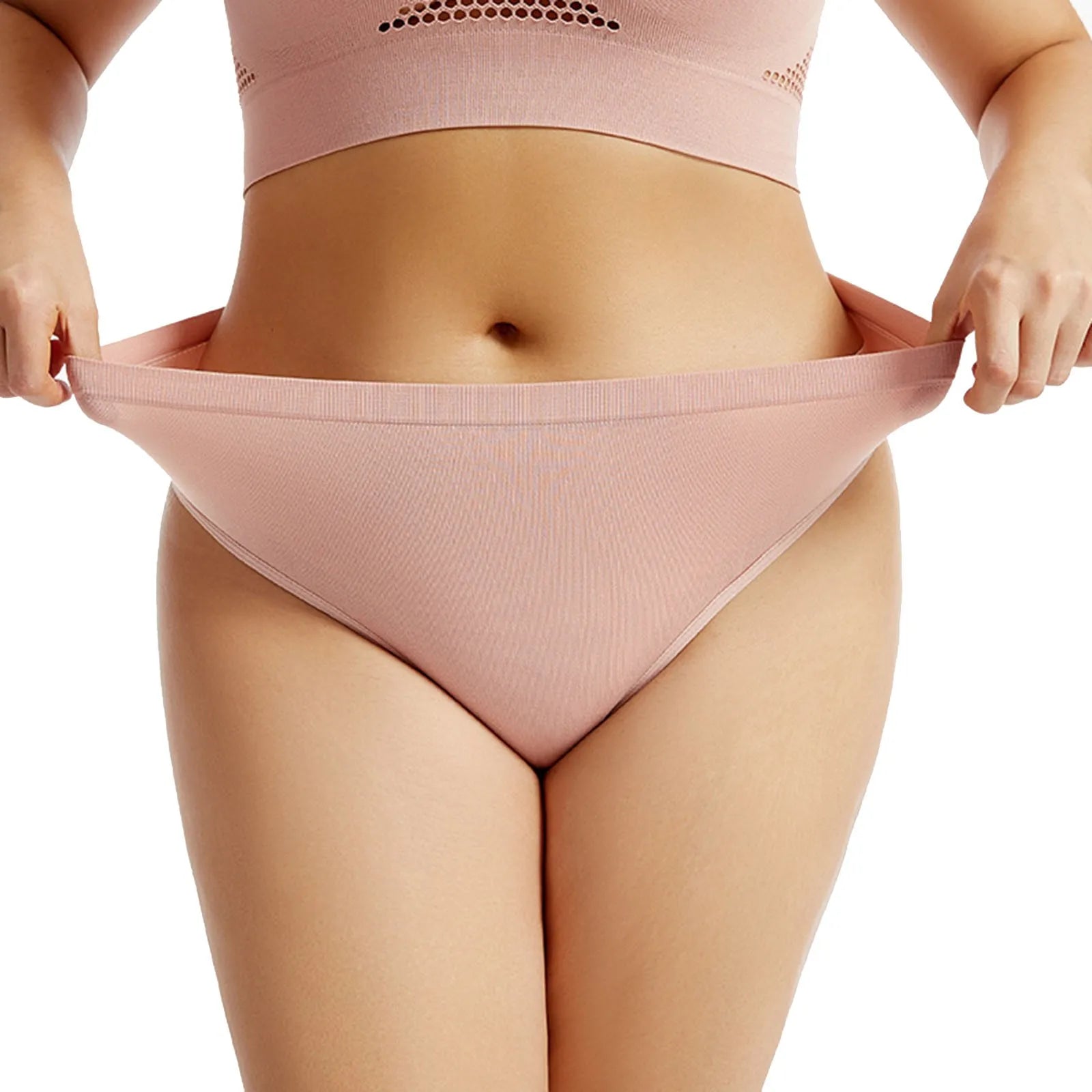 Person wearing a pink athletic bra and underwear set on a white background
