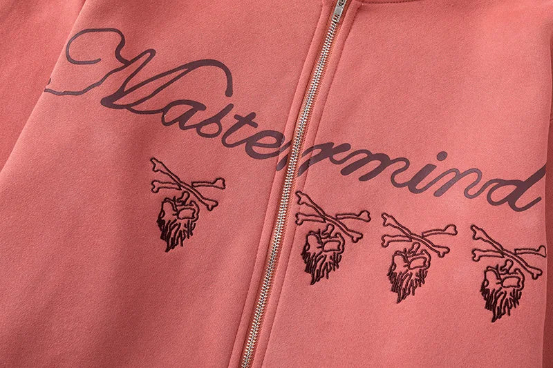 Pink hoodie with 'Mastermind' branding and logo on a plain background