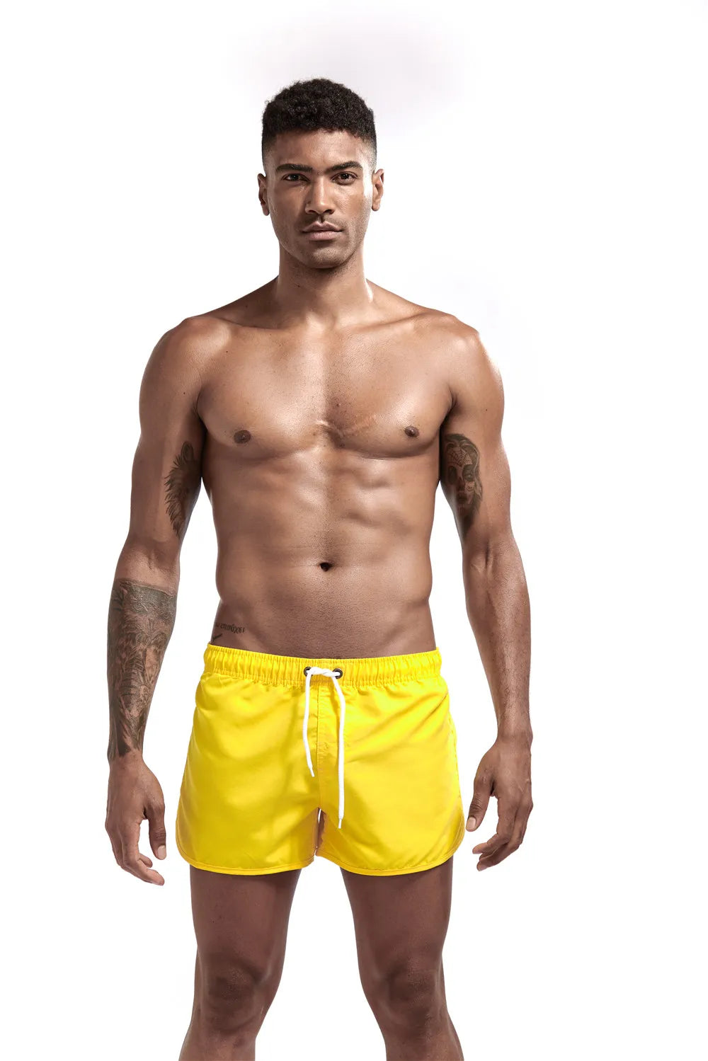 Man wearing yellow swim shorts on a white background