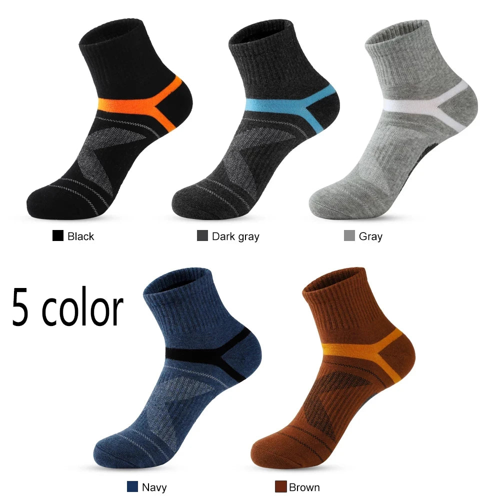 Five pairs of socks in black, dark gray, gray, navy, and brown on a white background.