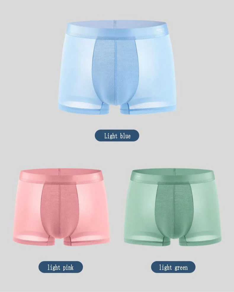 Three pairs of boxer briefs in light blue, light pink, and light green on a gray background.