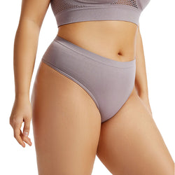 Person wearing a pair of gray high-waisted underwear on a white background