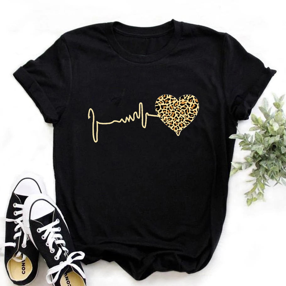 A black short-sleeve women's T-shirt with a leopard heartbeat print, displayed with sneakers and pants for scale. | 3KDyn
