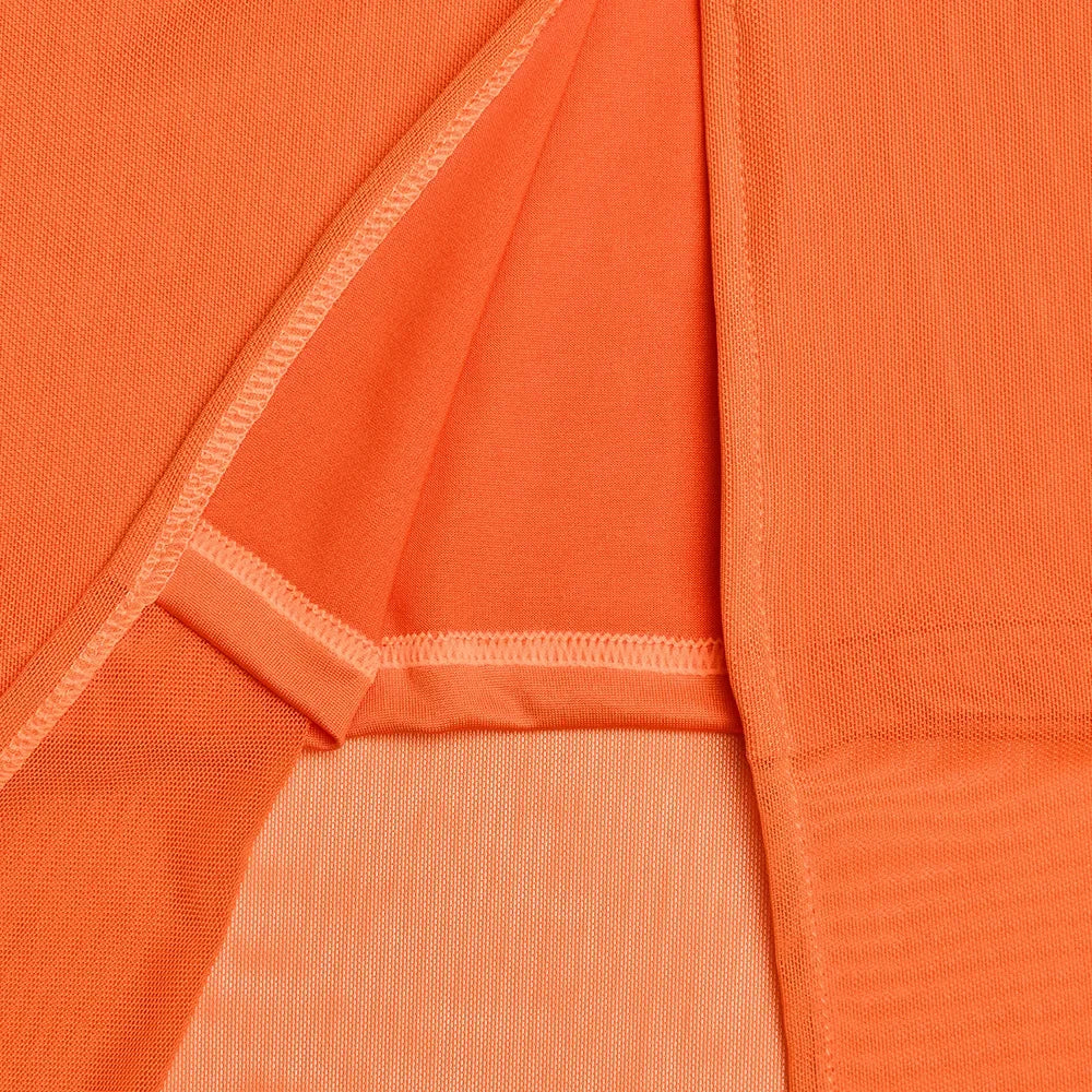 Close-up of orange fabric with a subtle pattern